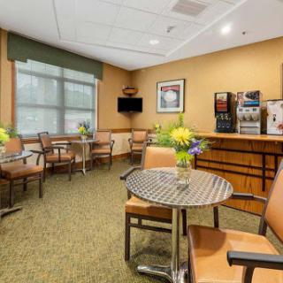 A cozy waiting area featuring comfortable seating and a coffee station.