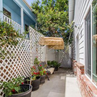 A cozy courtyard with potted plants and lattice fencing.