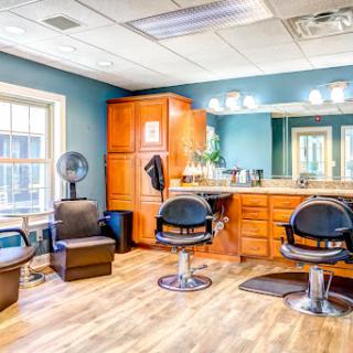 A well-designed hair salon featuring modern barber chairs and a cozy atmosphere.