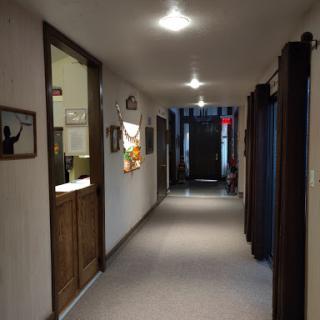 A well-lit hallway with multiple doors and decorative elements.