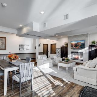 A modern open-concept living and dining area featuring a cozy fireplace, comfortable seating, and stylish decor.