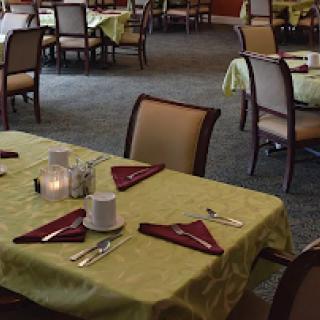 A spacious dining area featuring neatly arranged tables and chairs ready for guests.