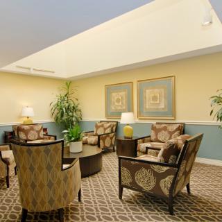 A cozy lobby seating area with armchairs and decorative elements.