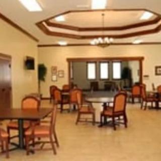 A spacious dining area with tables, chairs, and warm lighting.