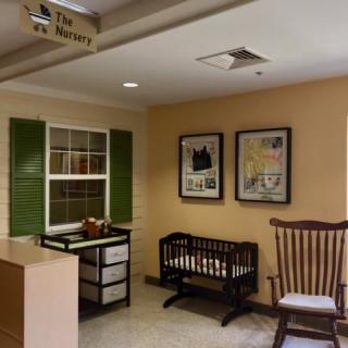 A cozy nursery room featuring a crib and a rocking chair.