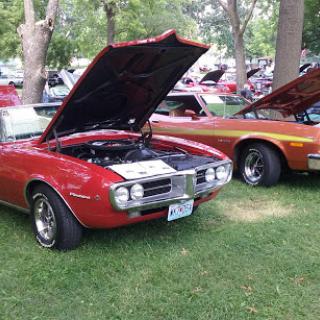 A vibrant display of classic muscle cars at a local car show.