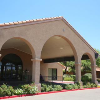 A building entrance featuring large arches and a covered walkway.