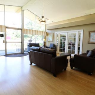 A spacious and inviting living room featuring comfortable sofas and ample natural light.