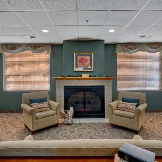 Cozy living room with a fireplace and two armchairs.