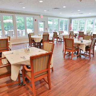 A bright and airy dining area with neatly arranged tables and chairs.