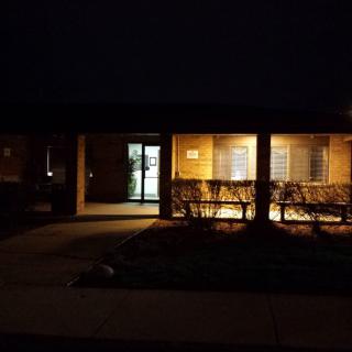 A building entrance illuminated at night.
