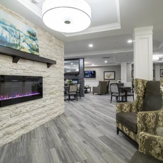 A modern living room with a stylish fireplace and comfortable seating.