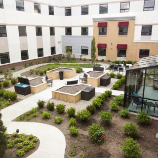 A modern courtyard with landscaped gardens and seating areas.