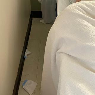 A glimpse of a bedroom with scattered items on the floor.