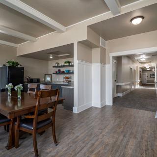 A modern dining area with wood flooring and contemporary furnishings in an open floor plan.