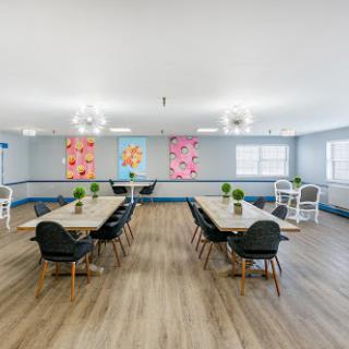 A modern meeting room featuring stylish furniture and vibrant artwork.