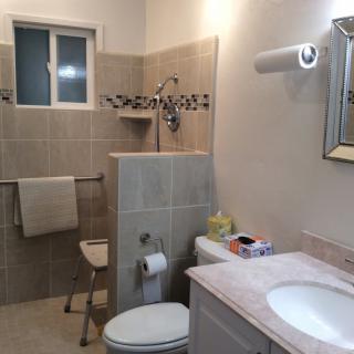A well-organized bathroom with a shower, sink, and toilet.