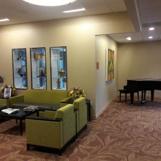 A welcoming lobby featuring modern seating and artwork, complemented by a piano.