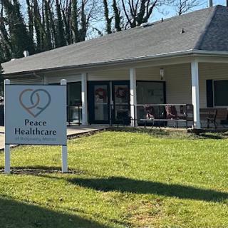 A healthcare facility with a welcoming sign and manicured lawn.