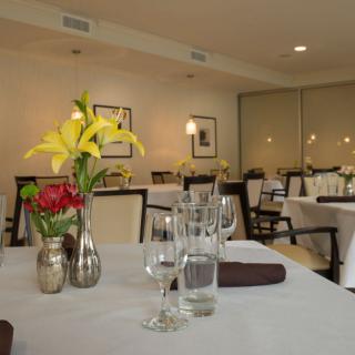 An elegantly set dining table in a sophisticated restaurant interior.