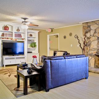 A cozy living room featuring a comfortable sofa, a mounted television, and decorative elements.