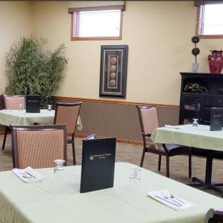 A quiet restaurant setting with neatly arranged dining tables, menus, and subtle interior decor.