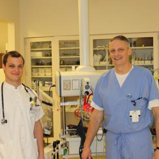 Two healthcare professionals posing in a hospital setting.