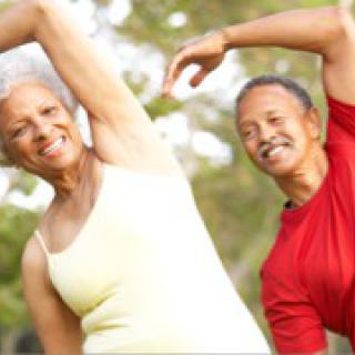 Two seniors enjoying outdoor exercise together.