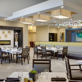 A modern, elegant restaurant dining area with well-arranged tables and stylish decor.
