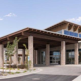 A modern commercial building with a large entrance and contemporary architectural design.