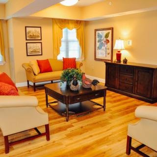 A cozy living room with elegant furniture and warm lighting.