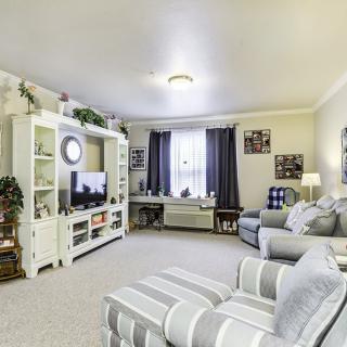 A cozy living room with comfortable seating and a neatly arranged entertainment center.