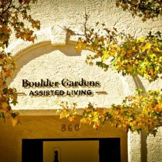 Entrance to Boulder Gardens Assisted Living with autumn leaves.