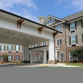 A modern residential building with a covered entrance.