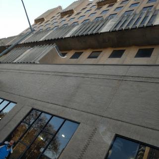 A view of a modern building from an upward angle, showcasing its architectural design.