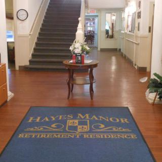 Lobby of Haye Manor Retirement Residence with a welcoming entrance and staircase.