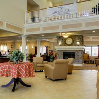A cozy lobby interior with comfortable seating and a fireplace.