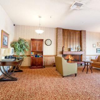 A cozy lobby area with comfortable seating and a fireplace.