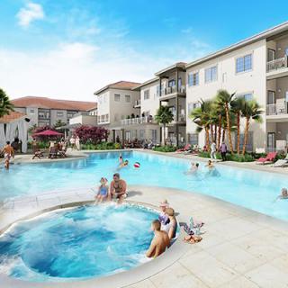 A relaxing pool area at a resort with a jacuzzi and people enjoying the sunny day.