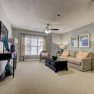 A stylish and cozy living room with a sofa, coffee table, and wall art.