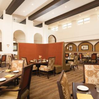 A spacious and elegantly designed dining area with comfortable seating and modern decor.