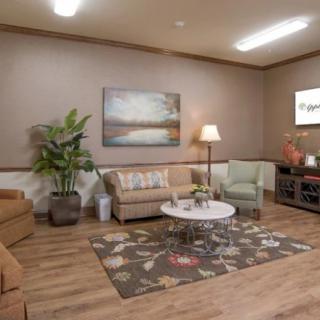 A cozy living room with sofas, a coffee table, and warm lighting.