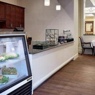 Interior view of a cafe with display cases and seating area.