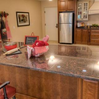 A modern kitchen with a central island and stainless steel appliances.