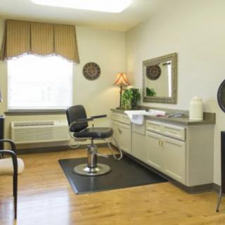 A tidy hair salon interior with a barber chair and mirror.
