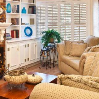 A cozy living room with comfortable seating, a bookshelf, and decorative elements.