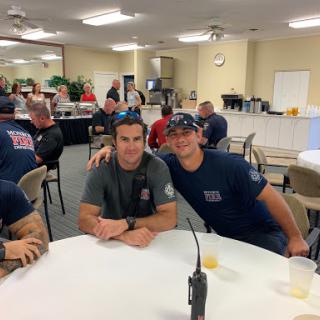 A group of firefighters enjoying their time together in a dining area.