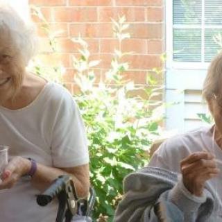 Two elderly women enjoying a sunny day together.
