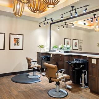 A modern hair salon with stylish decor and comfortable seating.