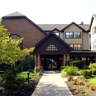 A well-maintained residential building with landscaped gardens at the entrance.